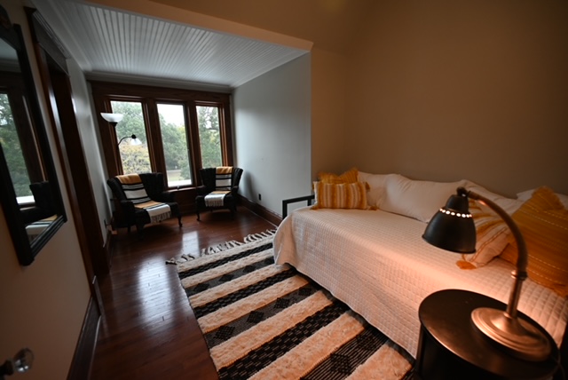 a room with a bed and a rug