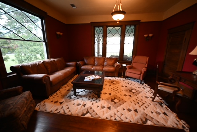 a room with leather couches and chairs