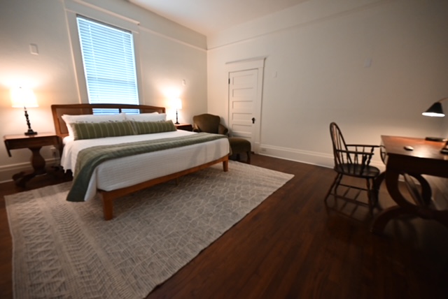 a bedroom with a bed and a chair