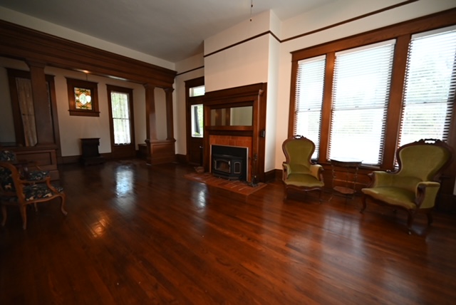 a room with wood floors and windows