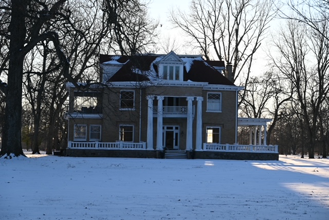 a large house with snow on the ground